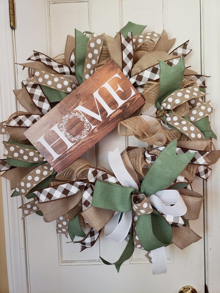 Round mesh wreath with sign that says home