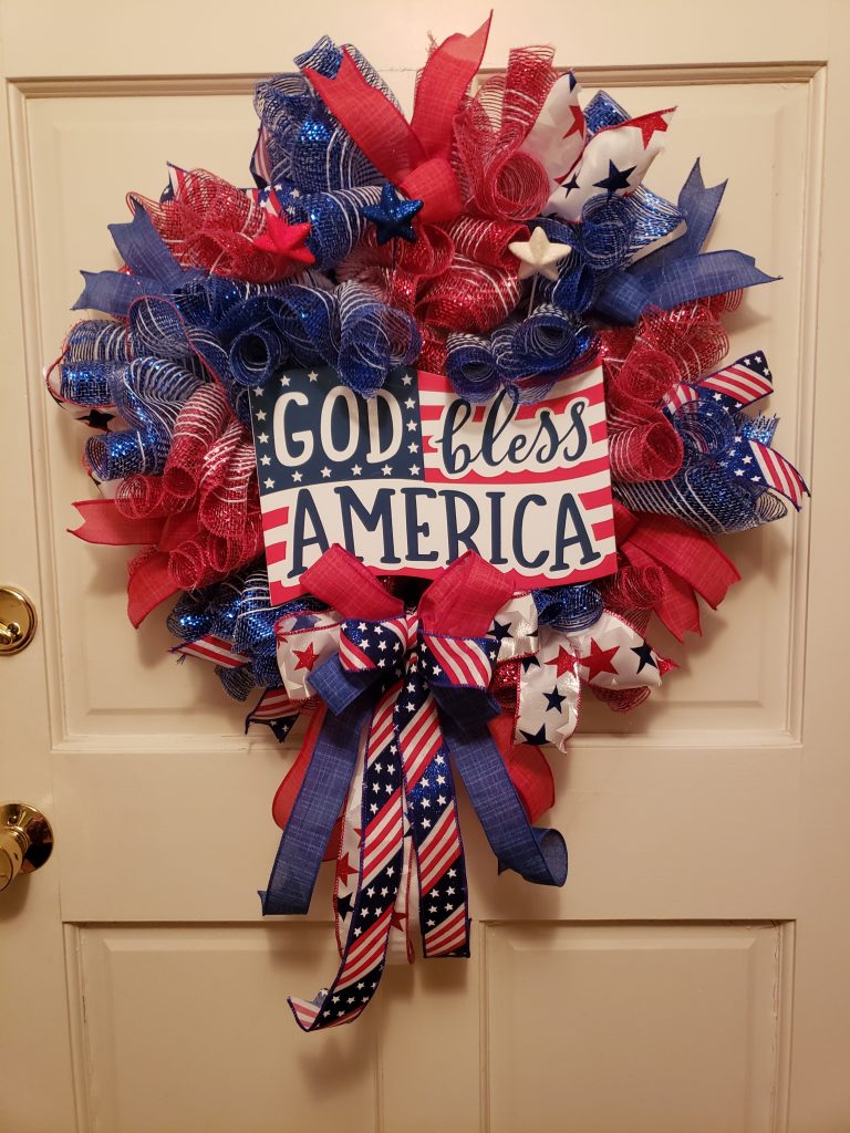 Round red white and blue wreath with sign